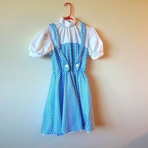Halloween costume of Dorothy from The Wizard of Oz including Toto